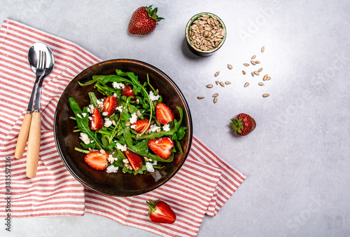 Diet menu. Healthy salad of fresh strawberries, arugula, ricotta and seeds on a bowl. Vegan food. Flat lay. Banner. Top view