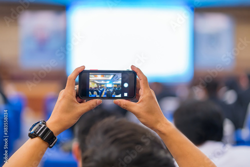 Wallpaper Mural Man taking photo to speaker on the stage present in conference hall or seminar meeting, event and seminar concept Torontodigital.ca