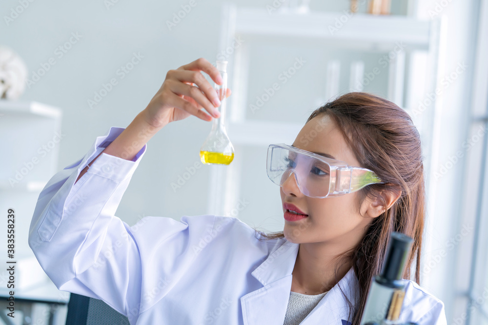 scientist woman lab technician assistant showing alcohol hand gel for cleaning hands at laboratory. Doctor and microbiologist with vacuum tubes for samples Virus resistance concept scientist woman lab technician assistant showing alcohol hand gel for cleaning hands at laboratory. Doctor and microbiologist with vacuum tubes for samples Virus resistance concept