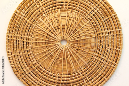 Close-up view of basketry plate isolated on a white background.