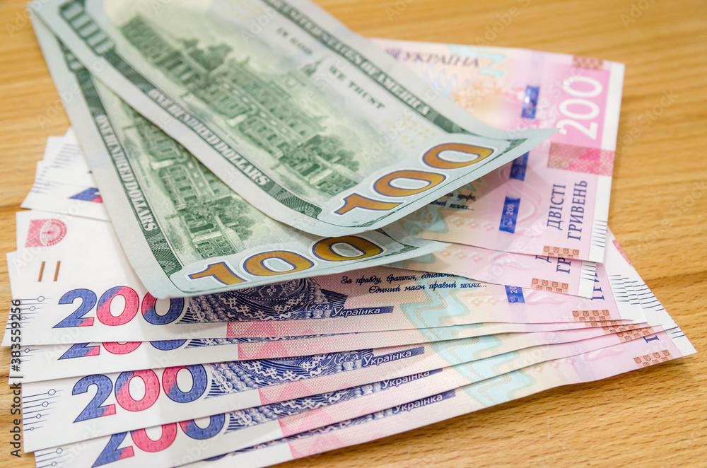 Banknotes of 100 American dollars and 200 Ukrainian hryvnias. The ratio of the hryvnia to the dollar. Exchange Rates. Banknotes of 100 American dollars and 200 Ukrainian hryvnias. The ratio of the hryvnia to the dollar. Exchange Rates.
