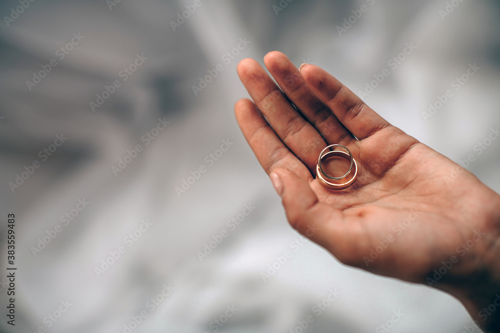 Woman hand holding wedding rings. Love concept. Wedding day. Sensual.
Woman hand holding wedding rings. Love concept. Wedding day. Sensual.