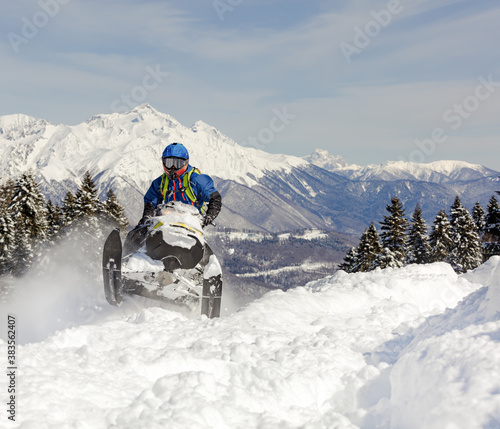 a Pro snowmobiler makes a jump with a big blast of snow and epic falls. Boondocker sports snowmobile