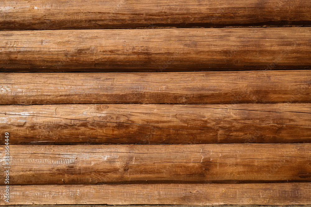 A wall of brown lacquer Logs. Textured background. A wall of brown lacquer Logs. Textured background.