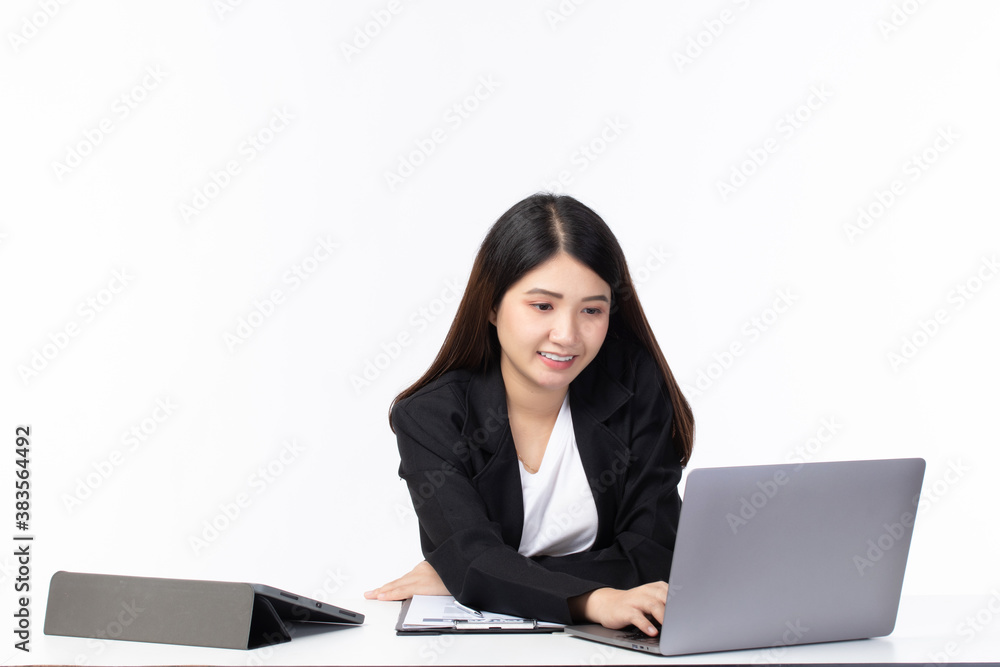 Beautiful young asian woman working on laptop computer while sitting smile, happy and relax at the office room isolated on white background. Beautiful young asian woman working on laptop computer while sitting smile, happy and relax at the office room isolated on white background.