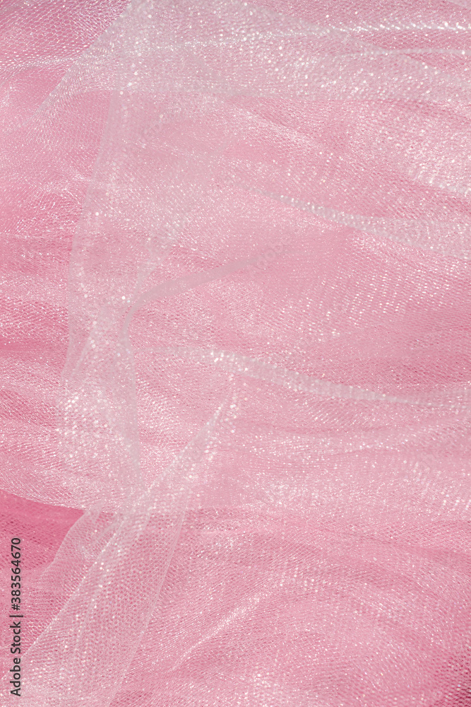 Fototapeta premium Pink tulle fabric texture top view. Coral background. Fashion color trends feminine tutu skirt flat lay, female blog backdrop for text signs desidgn. Girly abstract wallpaper, textile surface.