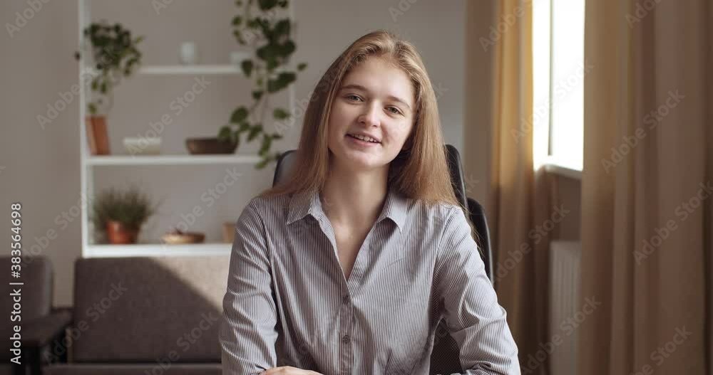 Portrait of teenage student girl or friendly business woman talking smiling, communicating with family friends colleagues in quarantine remotely from home online video conference, view from web camera Portrait of teenage student girl or friendly business woman talking smiling, communicating with family friends colleagues in quarantine remotely from home online video conference, view from web camera