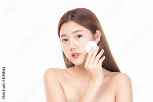 Attractive beauty young asian woman clean skin with cotton pad removing make up. Happy pretty girl cleaning her face with cotton pads isolated on white background