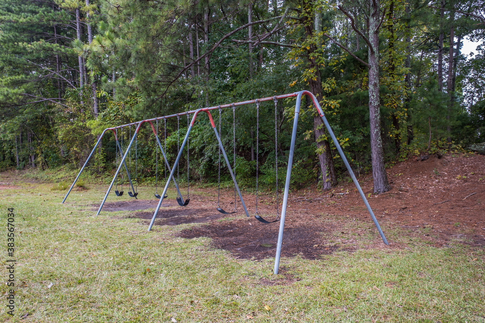 Empty playground swing set at the park
