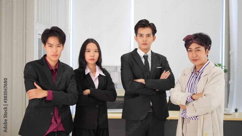 Group of Asian young lgbtq business team standing and look at camera in office business, LGBT with legal concept. Group of Asian young lgbtq business team standing and look at camera in office business, LGBT with legal concept.