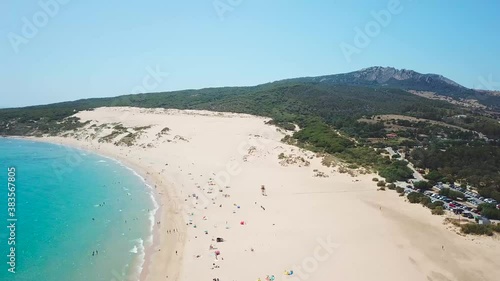 Aerial drone view of Natural Park of the Gibraltar Strait - Tarifa city CADIZ. View of Valdevaqueros Sand Dune. Famous tourist destination in South of Spain. Costa de Luz. Drone going up and left rota
