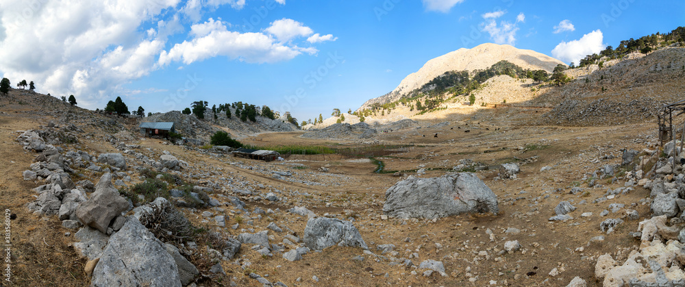 Alpine farm on Chukur Yayli. A huge valley in the mountains is surrounded by rocks. Panoramas of the Lycian trail in Turkey. Alpine farm on Chukur Yayli. A huge valley in the mountains is surrounded by rocks. Panoramas of the Lycian trail in Turkey.