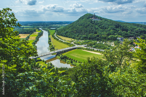 Emperor William Monument on top of Wittekindsberg and the Weser river on the left. Near the city of Porta Westfalica, North Rhine Westphalia, Germany. View from Portakanzel viewpoint. photo