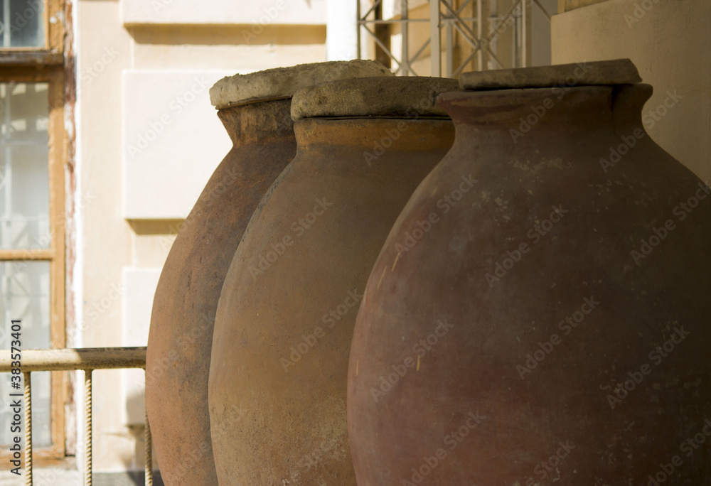 large ancient pithos clay vessels for storing wine, cereals and other products. vertical photo. south of Russia