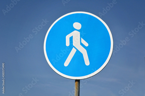 road sign pedestrian path against the sky