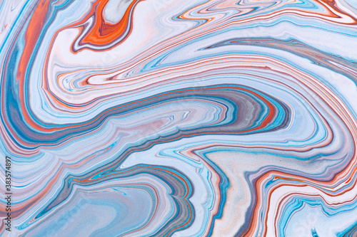 Fluid art texture. Abstract background with iridescent paint effect. Liquid acrylic picture with artistic mixed paints. Can be used for baner or wallpaper. Orange, blue and gray overflowing colors