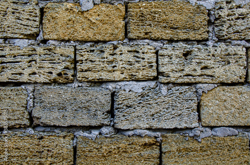 The wall is made of Crimean sandstone. Background and texture. photo