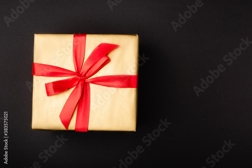 Top view of gift box with bow on black background
