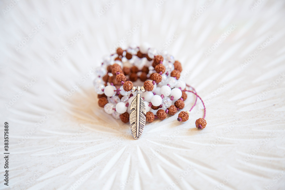 Fototapeta premium Indian seed and white jade beads mala necklace on white background