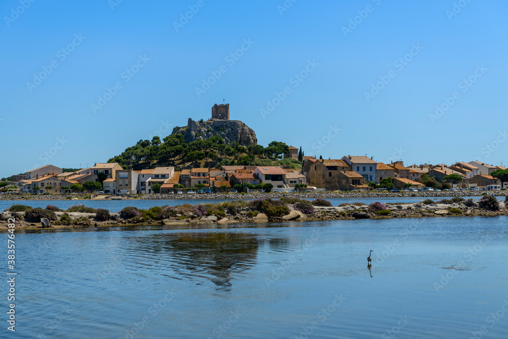 The ponds and the old Gruissan and the Barberousse tower in the background, in Aude in Occitanie, France The ponds and the old Gruissan and the Barberousse tower in the background, in Aude in Occitanie, France