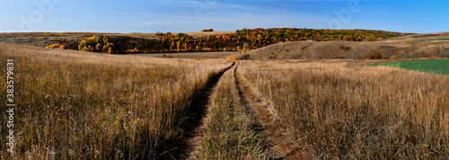 Panoramic landscape of central Russia agricultural countryside with hills and country road. Autumn landscape of the Samara valleys. Russian countryside. High resolution file for large format printing. © Dmitry Yakovtsev