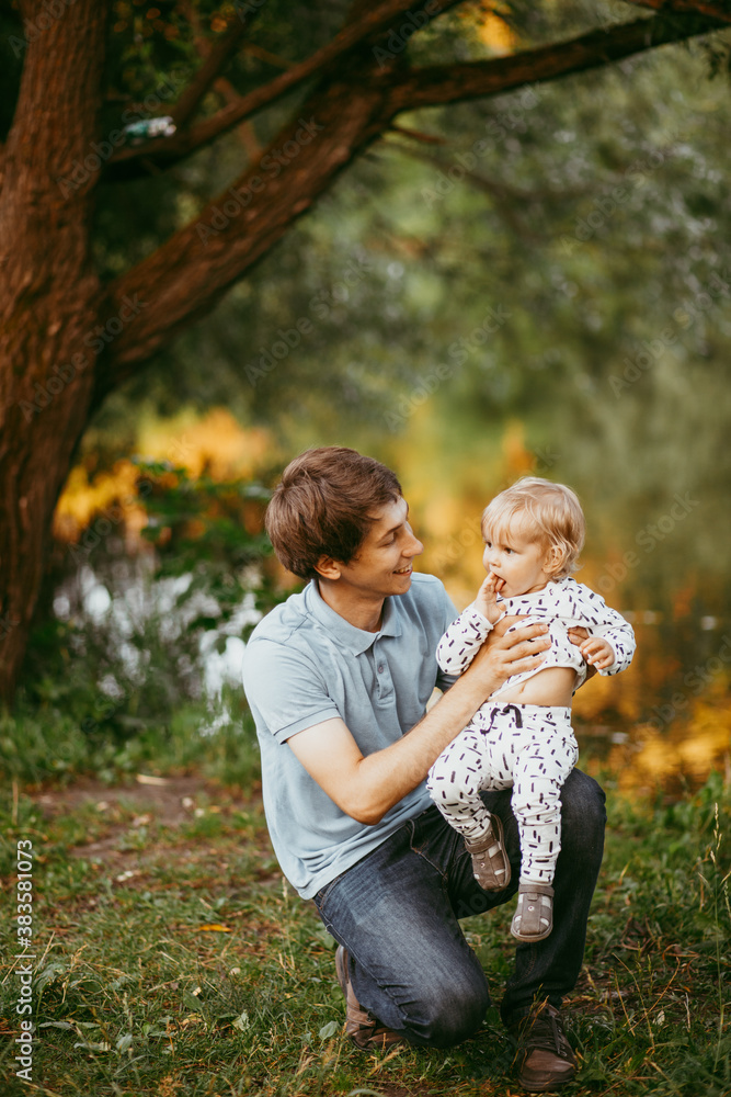 happy family father and son walking in nature happy family father and son walking in nature