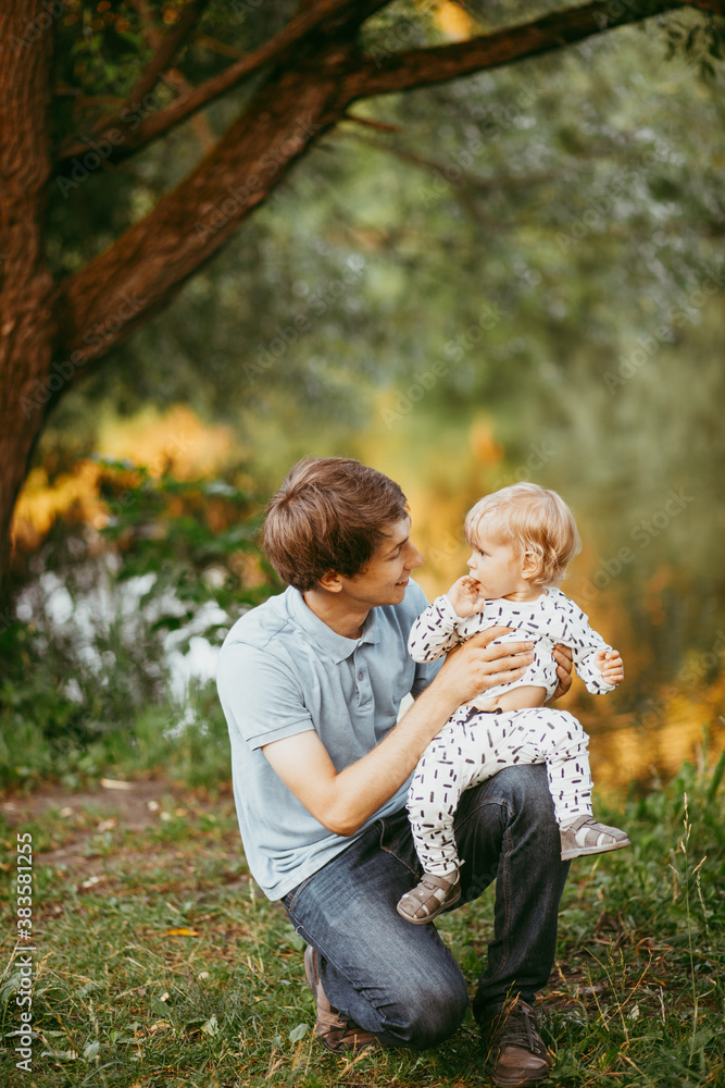 happy family father and son walking in nature happy family father and son walking in nature