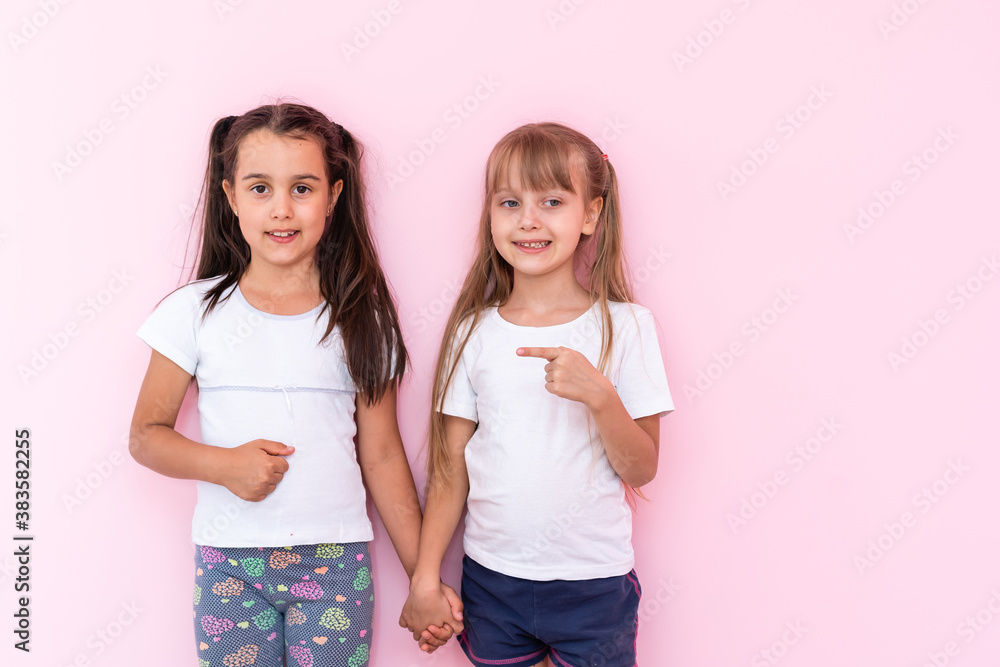 Happy funny girl twins sisters hugging and laughing Happy funny girl twins sisters hugging and laughing