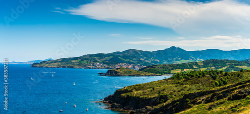 Steep coast of Roussillon, and in the background the village of Banyuls sur mer, in French Catalonia in Occitanie, France