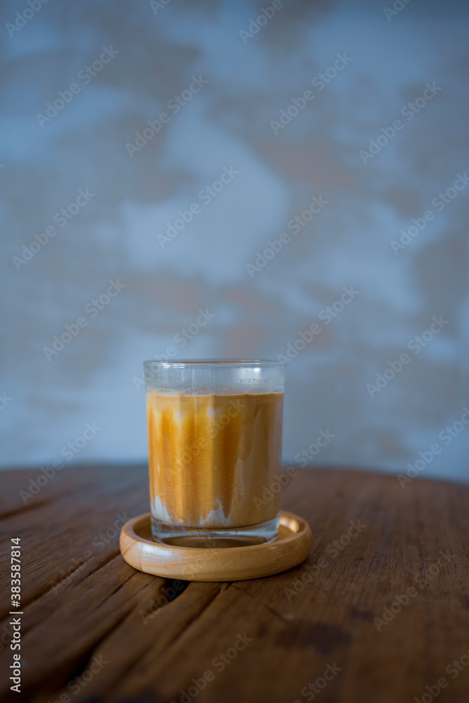 cup of dirty coffee made by adding espresso shot on extremely cold milk