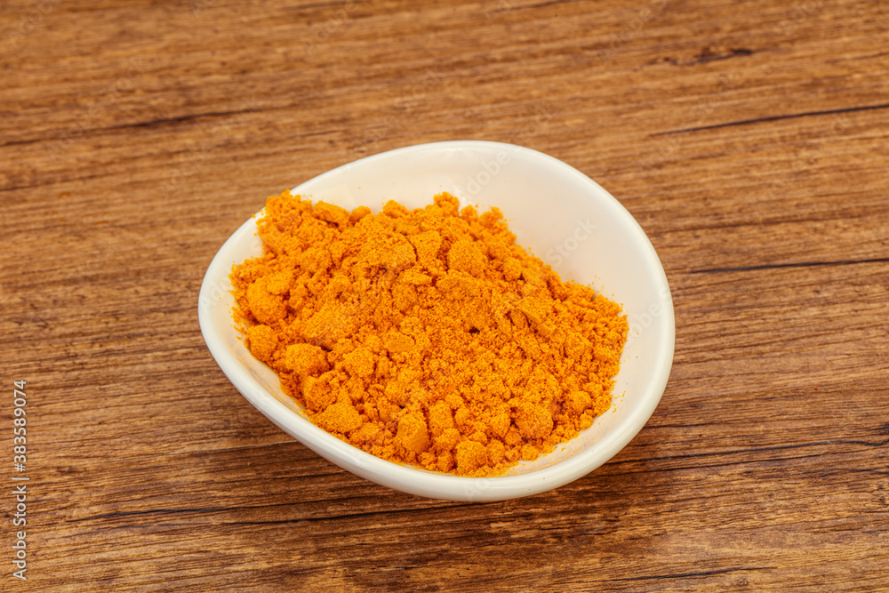 Tumeric powder in the bowl Tumeric powder in the bowl