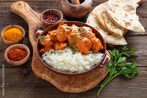 Chicken tikka masala spicy curry meat food in a clay plate with rice photo