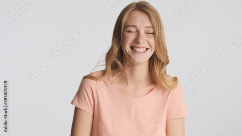 Attractive cheerful girl happily smiling on camera over white ba