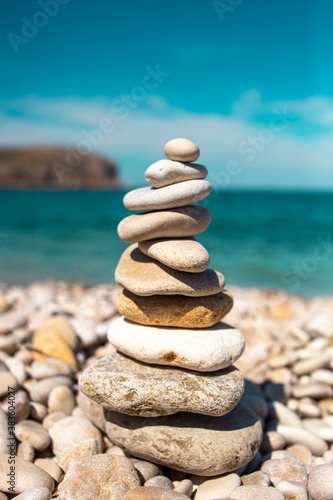 Stones placed in pyramid in a relaxing landscape on the beach