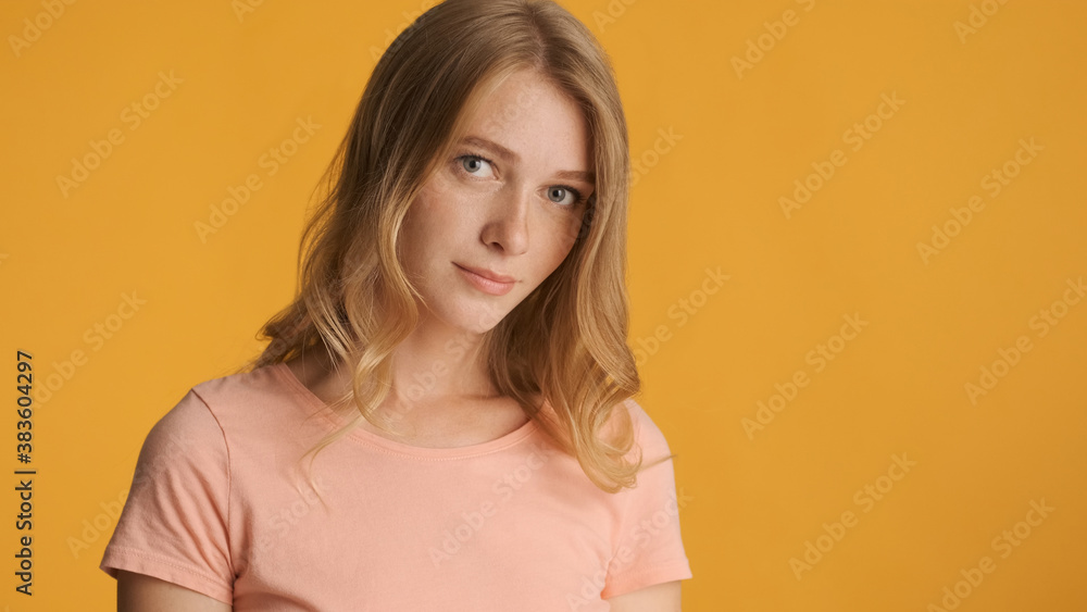 Beautiful shy girl posing on camera isolated on colorful backgro Beautiful shy girl posing on camera isolated on colorful backgro