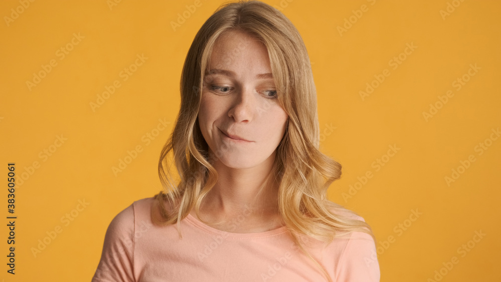Doubtful girl thinking on camera over colorful background. Thoug Doubtful girl thinking on camera over colorful background. Thoug