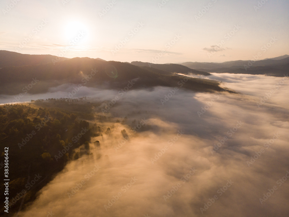 Aerial view of autumn sunset in mountains with fog and cloud landscape