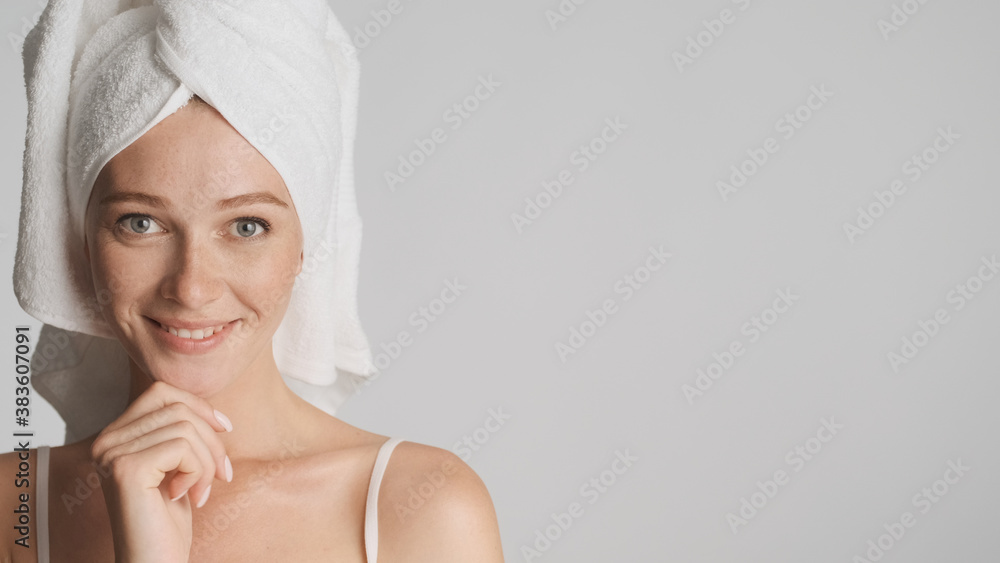Beautiful girl with towel on head happily looking in camera over Beautiful girl with towel on head happily looking in camera over