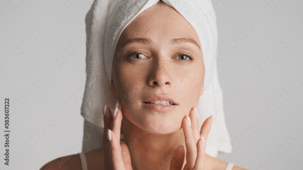 Close up girl with smooth skin and towel on head posing on camer Close up girl with smooth skin and towel on head posing on camer