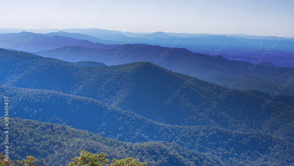 Fototapeta premium The Blue Ridge Mountains appear like waves of an ocean that goes on forever.