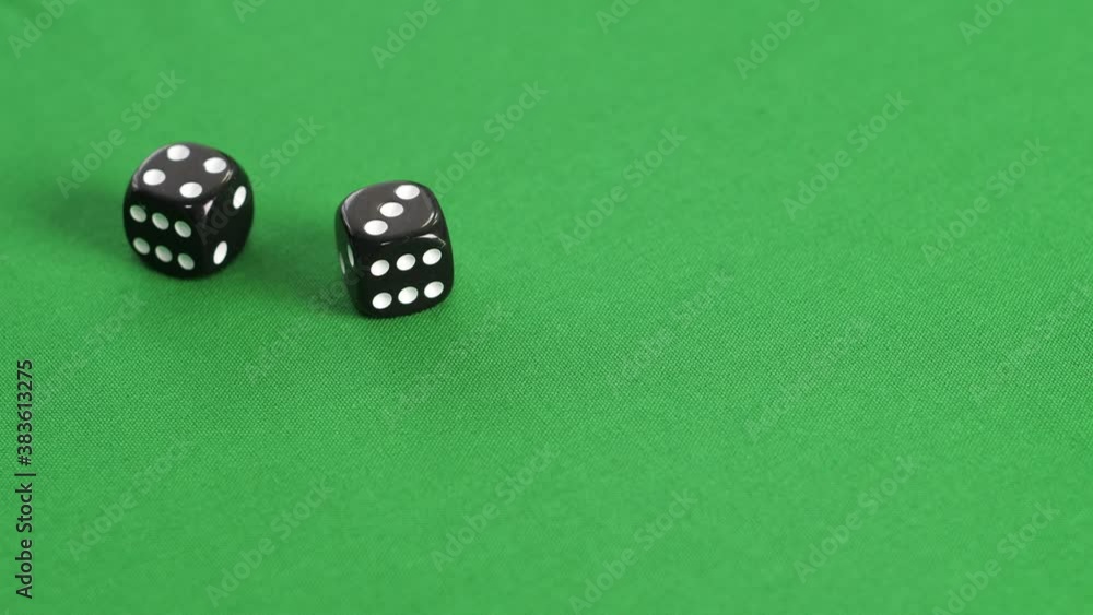 Double dice game on green casino table. Player throwing double dice four and three on gaming table. Rolling cubes dice. Gambling and casino concept Double dice game on green casino table. Player throwing double dice four and three on gaming table. Rolling cubes dice. Gambling and casino concept