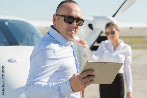 Wallpaper Mural beautiful stylish couple in official clothes near private plane Torontodigital.ca