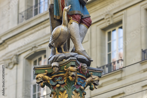 The medieval Pfeiferbrunnen fountain and statue standing on the colorful pillar in Bern, Switzerland