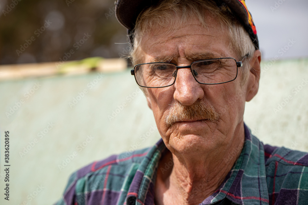 portrait of man in his sixties who works outdoors on the land portrait of man in his sixties who works outdoors on the land