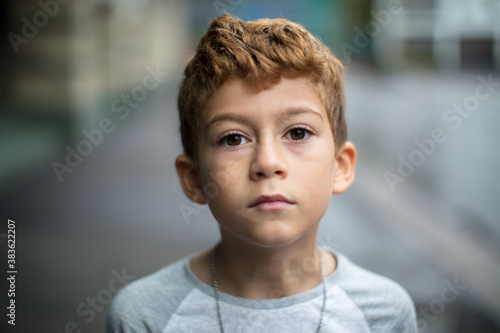 Young boy staring into the camera photo