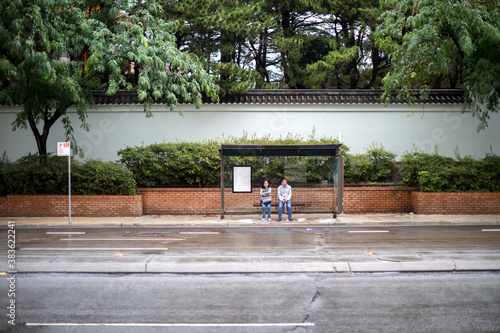 Tourist couple waiting at bus stop in Darling Harbour photo