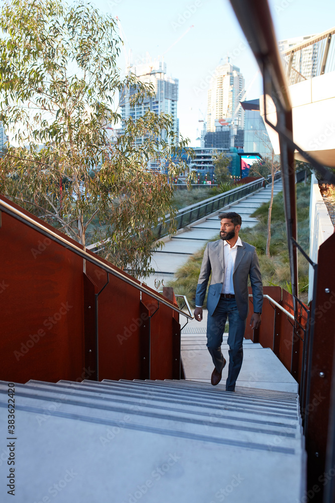 Indian businessman with open collar cheerful outdoors in city Indian businessman with open collar cheerful outdoors in city
