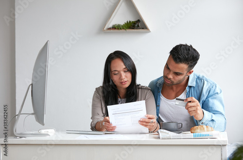 Young couple stressing over credit card debt photo