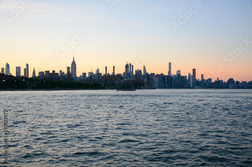 New York, NY, USA - June 27, 2019: Manhattan view from the ferry which follows to 34th Street from Brooklyn Bridge Park