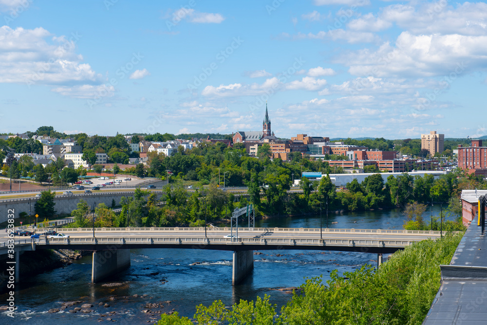 Manchester historic city skyline including Merrimack River, Granite Street Bridge and West Side Sainte Marie Parish church in Manchester, New Hampshire NH, USA. 